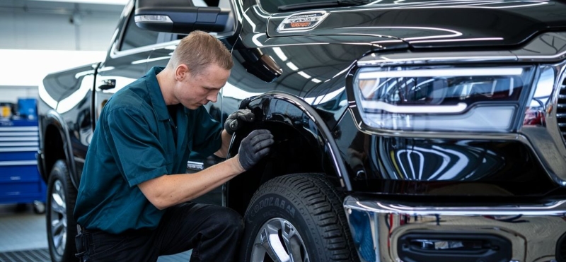 Paintless Dent Repair tech working on RAM