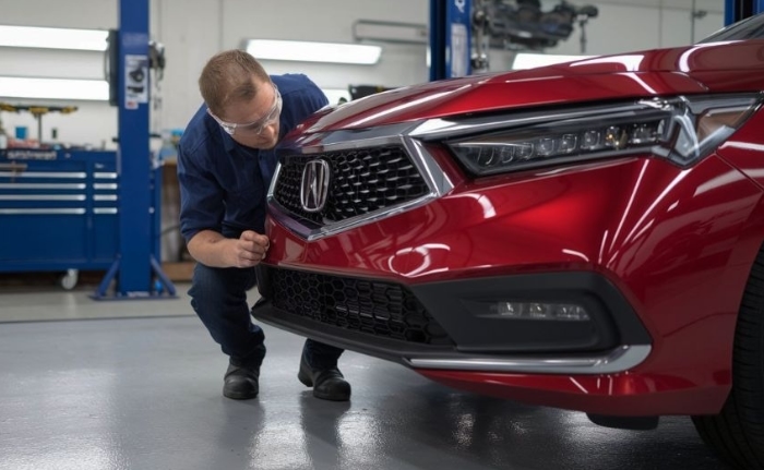 Certified Collision Repair tech inspecting acura