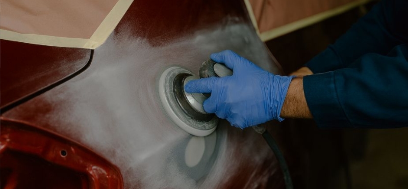 Lake Bluff Collision Repair tech sanding quater panel